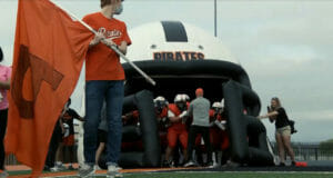Putnam City Pirates wait inside a gigantic inflatable helmet for their cue to take the field